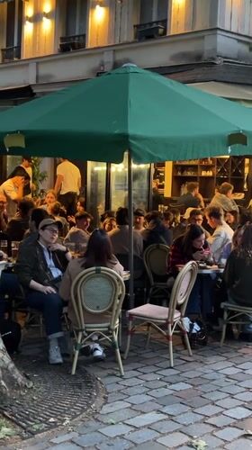 Evening Paris scenes show cafe life, river boat, Notre Dame restoration