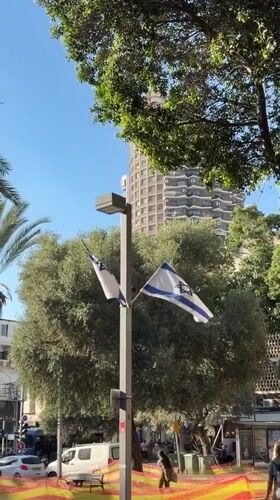 Israeli flags displayed on Tel Aviv street pole