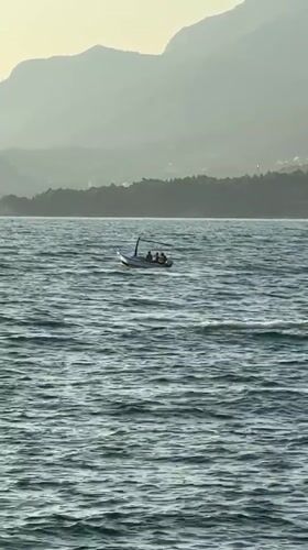 Small boat navigates calm hazy waters off Bar, Montenegro