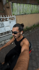 Man rides scooter on rural brick road in North Kuta