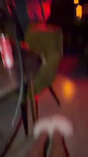 Woman smokes hookah in red-lit Dalung lounge