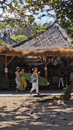 Kuta Beach morning: kites, boards, and beachside activity