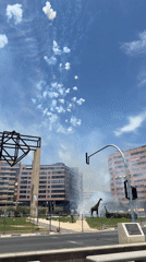 Controlled pyrotechnic display monitored by firefighter in public square