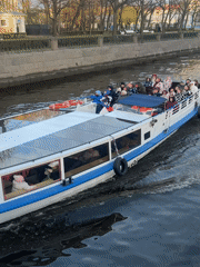 Tourist boats cruise Saint Petersburg canals near historic landmarks