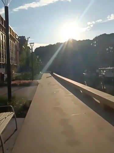 Peaceful canal scene documented in Leuven with boats and buildings