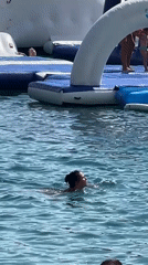 Budva beach and inflatable water park on a busy summer afternoon