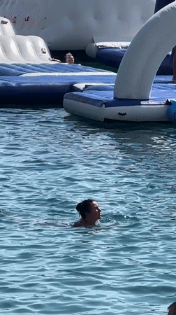 Budva beach and inflatable water park on a busy summer afternoon