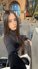 Young woman takes selfies around busy Yerevan streets