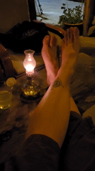 Person enjoys afternoon cocktail in dimly lit Đà Nẵng venue