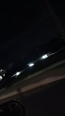 Nighttime drive through rainy city streets with heavy traffic