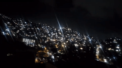 Nighttime cityscape of illuminated Caracas captured from elevated viewpoint