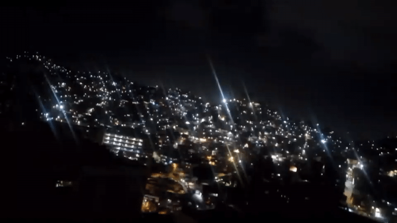 Nighttime cityscape of illuminated Caracas captured from elevated viewpoint