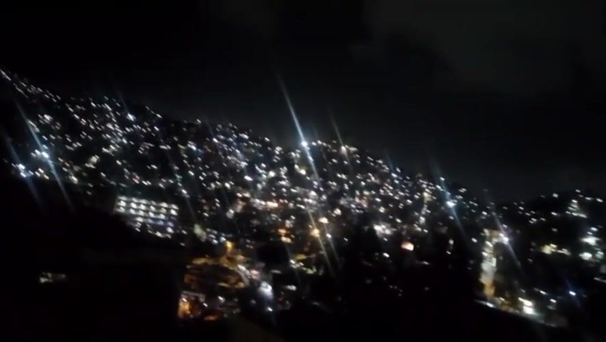 Nighttime cityscape of illuminated Caracas captured from elevated viewpoint