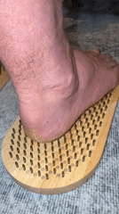 Person stands on spiked wooden boards in Norway home