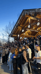 Krasnoyarsk residents gather outdoors, sunset scene captured nearby