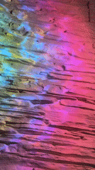 Stone wall illuminated by shifting multicolored light display