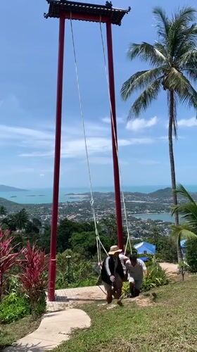 Tourist visits scenic Ko Samui hilltop swing viewpoint