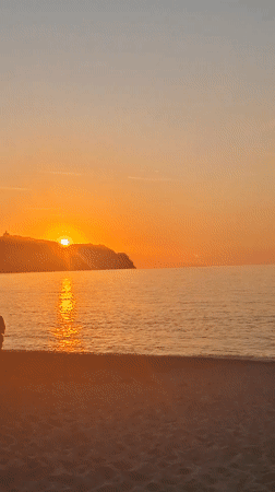 Witness captures sunset/sunrise over ocean from beach May 24