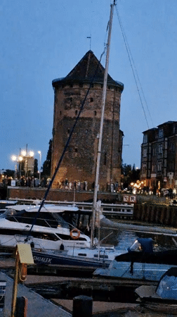 Gdańsk waterfront at dusk — marina, boats, and old town