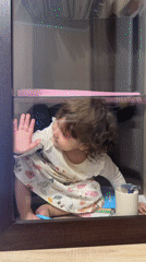 Child plays in glass display cases in Tobolsk