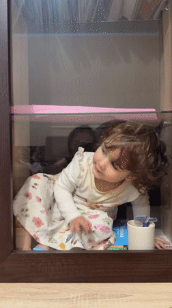 Child plays in glass display cases in Tobolsk