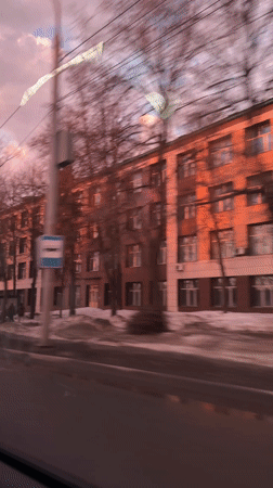 Passenger captures dramatic pink clouded sky from moving car