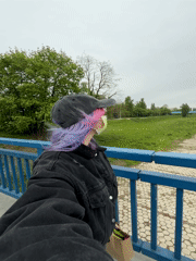Masked individual films on Zagreb bridge amid spring blooms