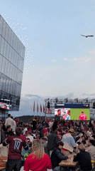 Outdoor fan zone crowd watches live sports on big screen in Stavanger