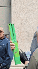 Group gathers on Milan street displaying green Swatch watch