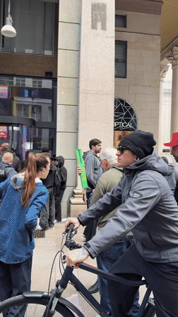 Group gathers on Milan street displaying green Swatch watch
