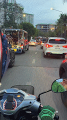 Scooter rider navigates heavy traffic in Pattaya City