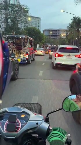 Scooter rider navigates heavy traffic in Pattaya City