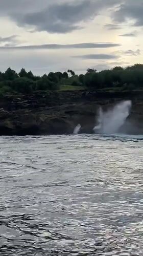Dramatic waves crash against cliffs at Nusa Penida, Indonesia