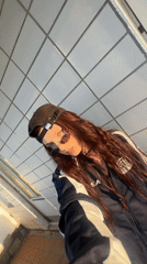 Woman takes selfie in athletic wear against Moscow wall