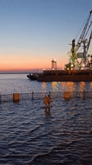 Amur River floods Khabarovsk embankment at dusk