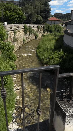 Town center exploration with river, fountain, and historic architecture