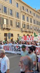Union protesters march through Milan's shopping district with flags