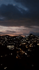Evening cityscape documented across Caracas hillsides during twilight hours