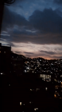 Evening cityscape documented across Caracas hillsides during twilight hours