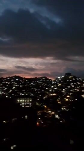 Evening cityscape documented across Caracas hillsides during twilight hours