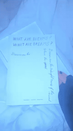 Person unboxes limited edition art book in UK bedroom