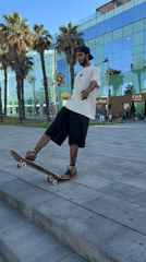 Skateboarders practice tricks near Barcelona beach during afternoon session