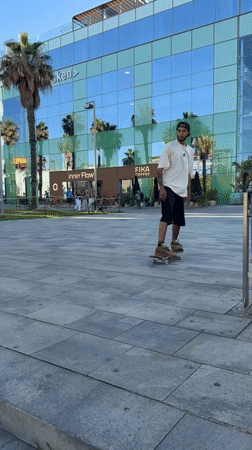 Skateboarders practice tricks near Barcelona beach during afternoon session