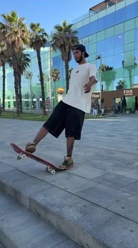 Skateboarders practice tricks near Barcelona beach during afternoon session