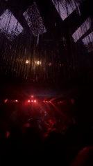 Red-lit stage and silhouetted performers at a Saint Petersburg venue