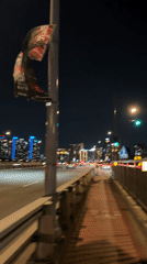 Damaged banner spotted on Seoul bridge during nighttime traffic