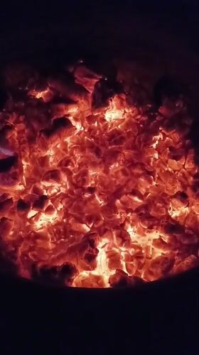 Evening fire pit gathering documented in Viadana, Italy
