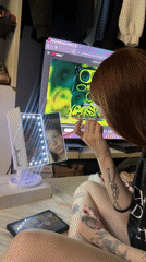 Woman applies makeup while watching TV in Buenos Aires bedroom