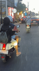 Two-person scooter spotted on busy Ubud street