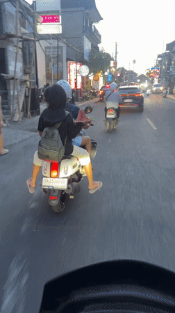 Two-person scooter spotted on busy Ubud street
